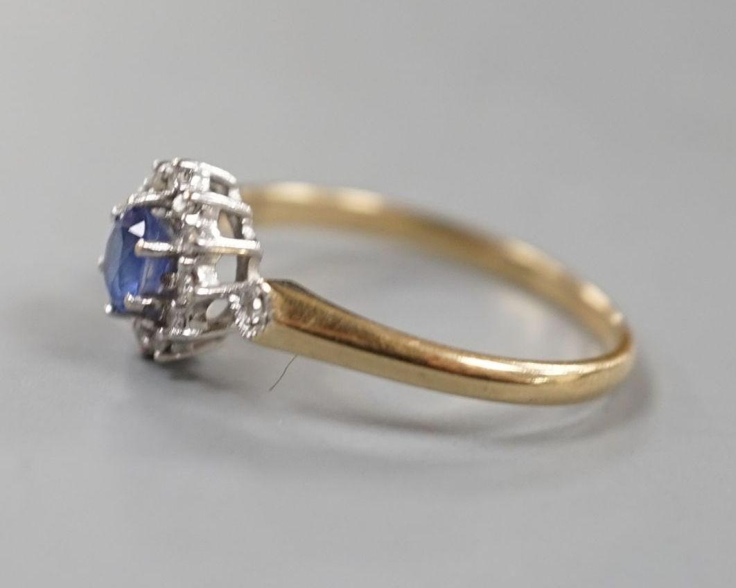 A modern 9ct gold, sapphire and diamond set cluster ring, size R, gross 2.3 grams.
